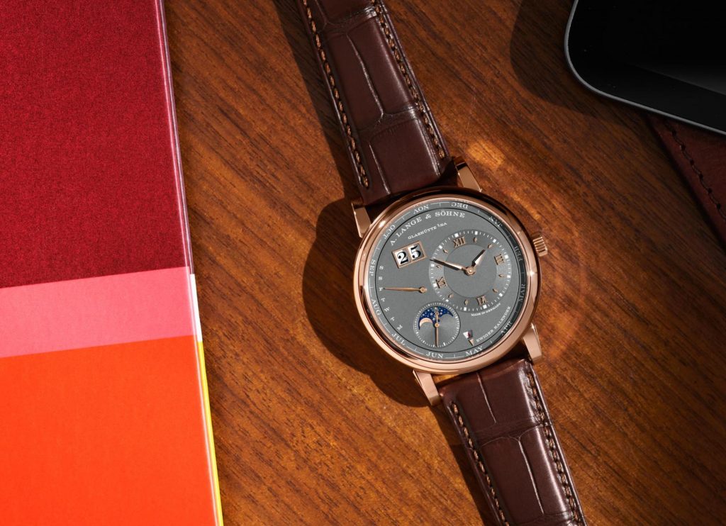 The 18k rose gold faeke watch has a grey dial.