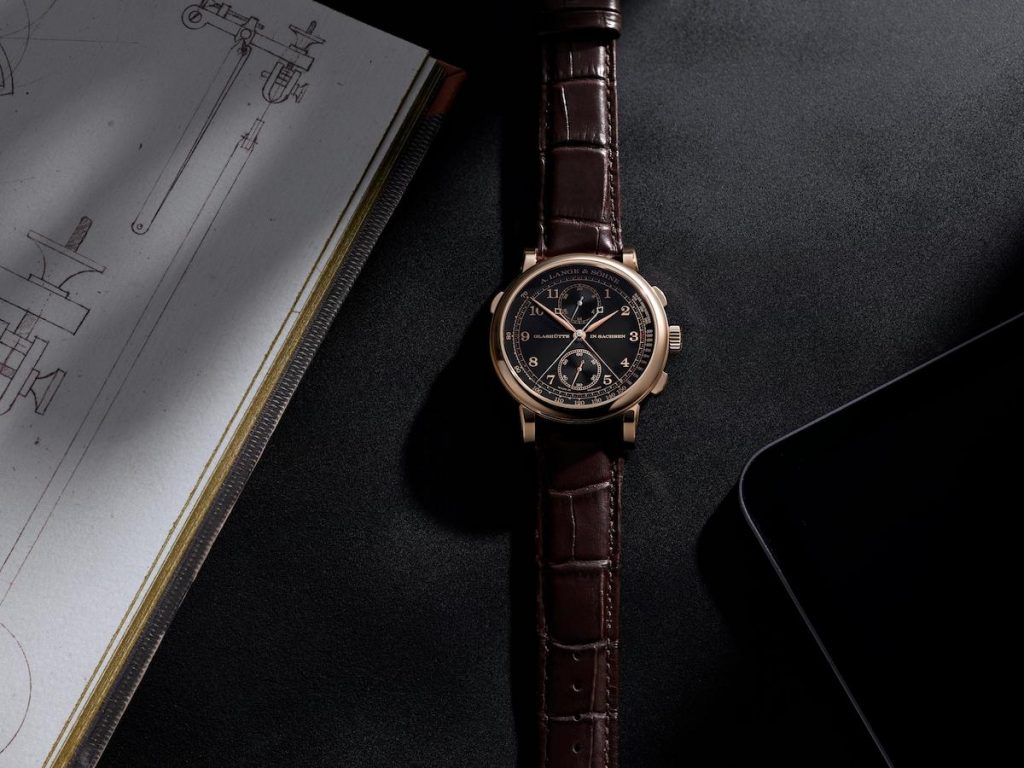 The brown strap replica watch has a black dial.